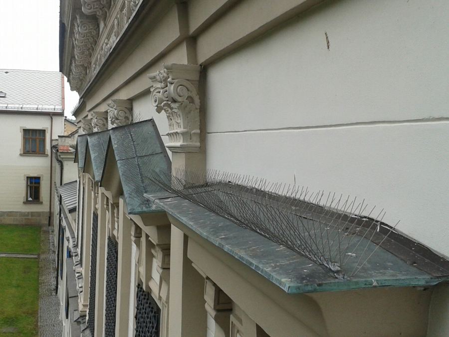 Nerezové hroty na římse a hlavicích pilastrů